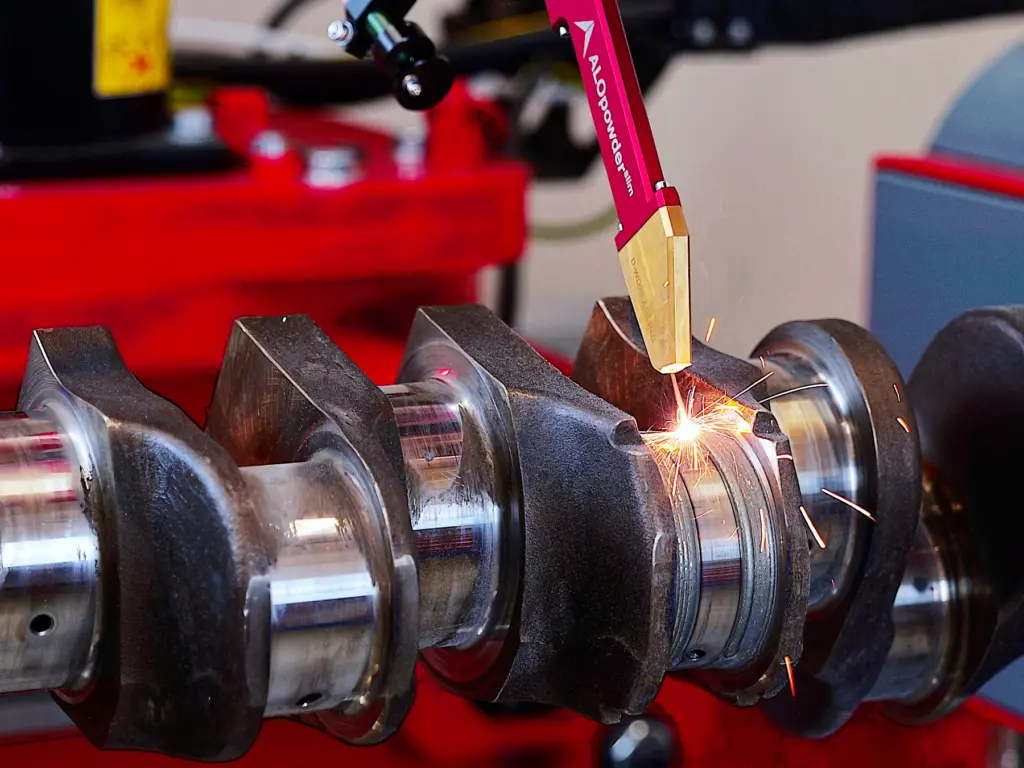 Narrow powder nozzle for build-up welding in marine ship repair, e.g., for crankshafts
